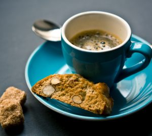 cup of coffee and bread on saucer closeup photography