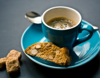 cup of coffee and bread on saucer closeup photography