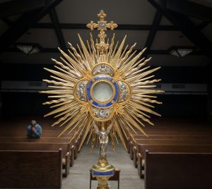 gold-colored cross table decor on top of brown wooden table