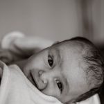 A Baby in a Robe with a Cross during Baptism