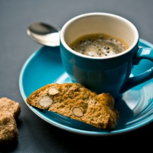 cup of coffee and bread on saucer closeup photography